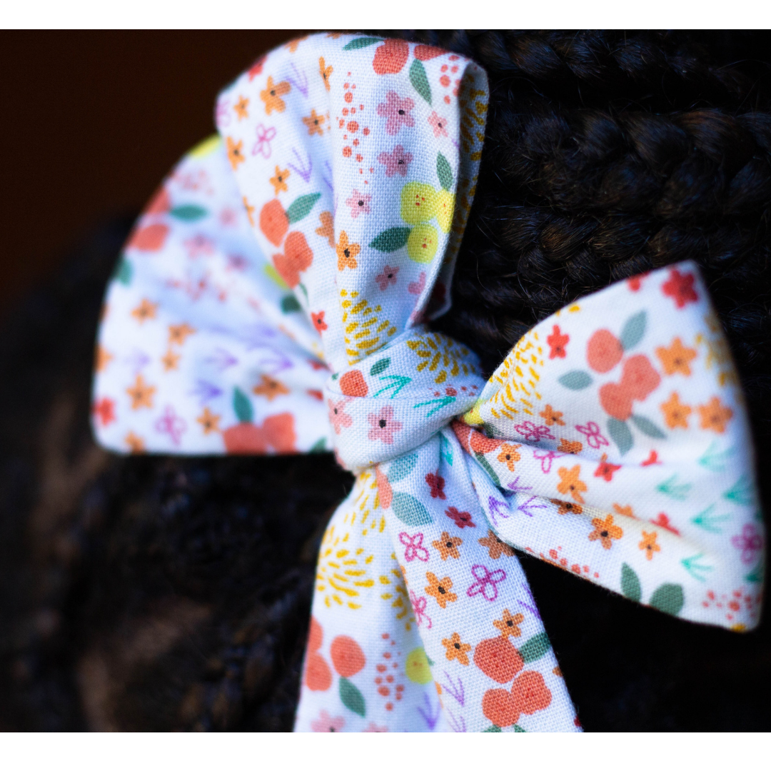 March Blooms florals pinwheel hair bow in braided hair