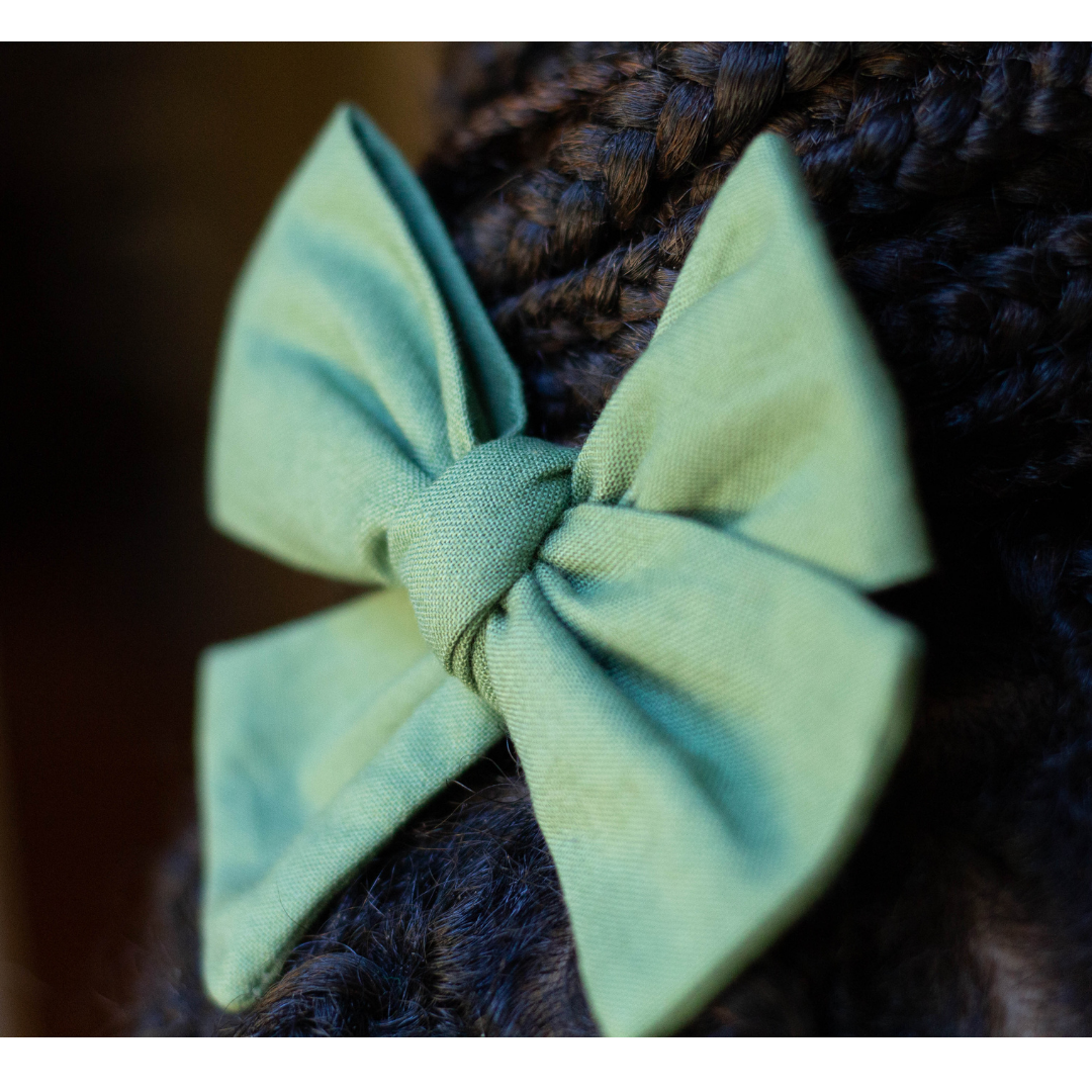 Moss Green Pinwheel hair bow in braided hair