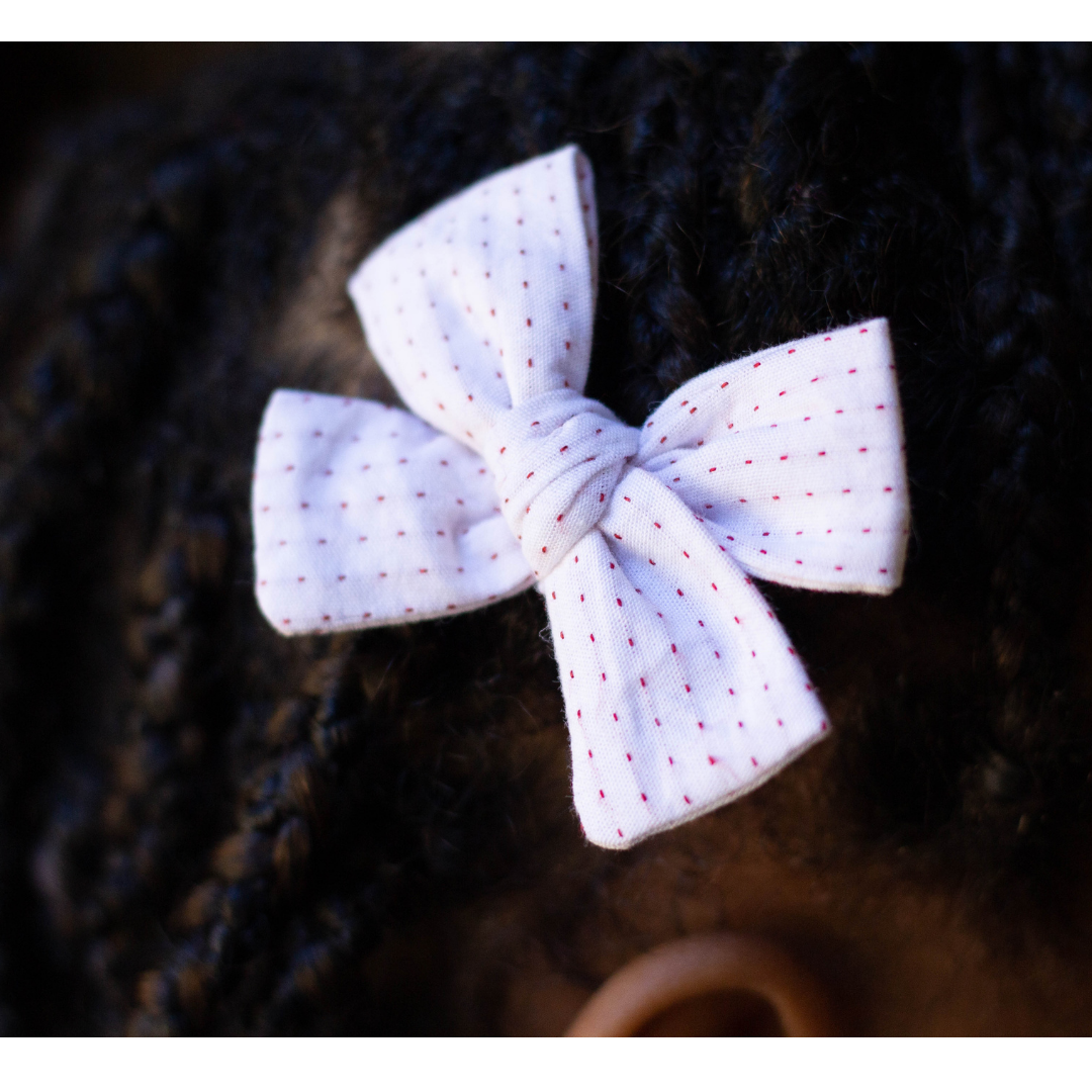 red and white hair bow in girls hair
